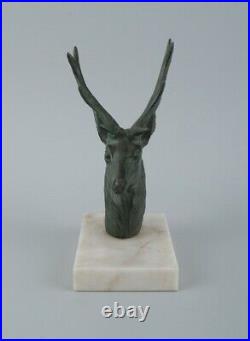 A pair of French Art Deco bookends. Stags in patinated metal on a marble base