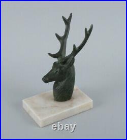 A pair of French Art Deco bookends. Stags in patinated metal on a marble base